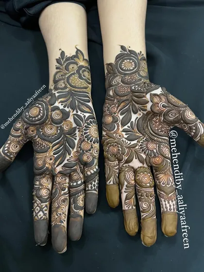 A full-hand design with a mix of bold floral work and delicate patterns, created on public demand.