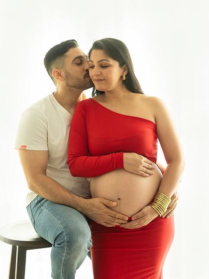 A tender moment captured in natural light. The simplicity of the setting allows the couple's connection to be the main focus of the photograph.