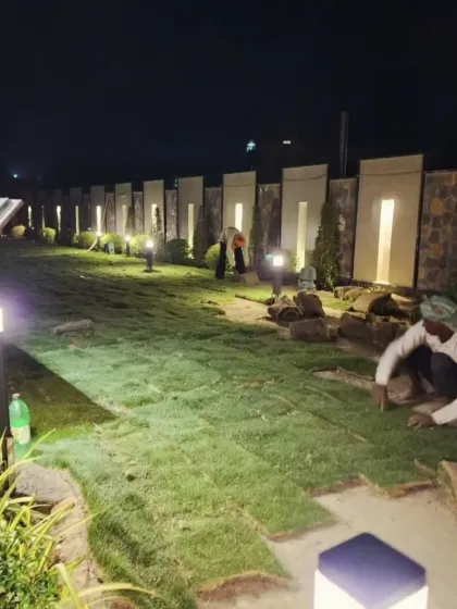 Another angle of the night-time installation process. My experienced gardeners, or maalis, work carefully to ensure each section of the turf carpet is perfectly aligned for a seamless finish.