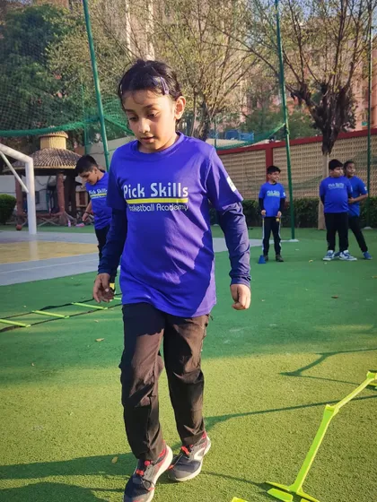 A young player concentrates while moving through an agility ladder. Our coaching extends beyond the session, providing guidance to help every player move forward and continuously improve their physical conditioning.