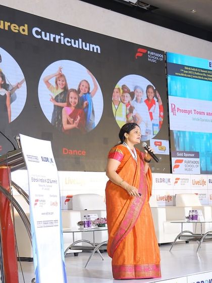 I present my structured curriculum for music, dance, and drama at an education summit. This demonstrates how my programs are designed to be comprehensive, covering a wide range of performing arts to ensure holistic student development.