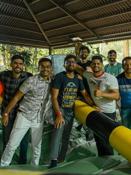 A team celebrates a win at the Meltdown inflatable game, a fun and bouncy challenge for everyone.