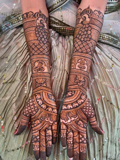 A beautiful bridal design with peacocks, elephants, and kalash motifs. The dense, symmetrical patterns are perfect for a bride who wants a grand and traditional mehendi.