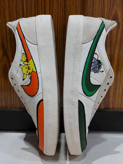 This top-down view highlights the distinct design on each shoe. The orange and green color schemes for Pikachu and Bulbasaur are clearly visible, making this a truly one-of-a-kind pair of custom kicks.