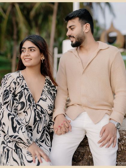 A lovely, hand-in-hand portrait of the couple against a backdrop of palm trees.