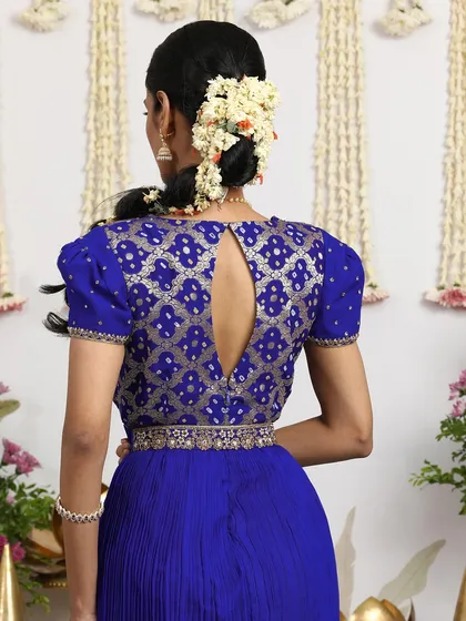 The back of the royal blue gown showcases the intricate Bandhani pattern and the elegant keyhole design.