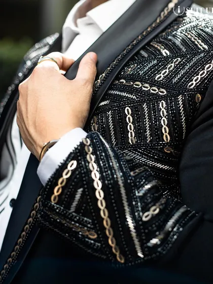 A close-up on the shoulder of a client's tuxedo, showing the incredible detail of the geometric beadwork. This is where craftsmanship truly shines.