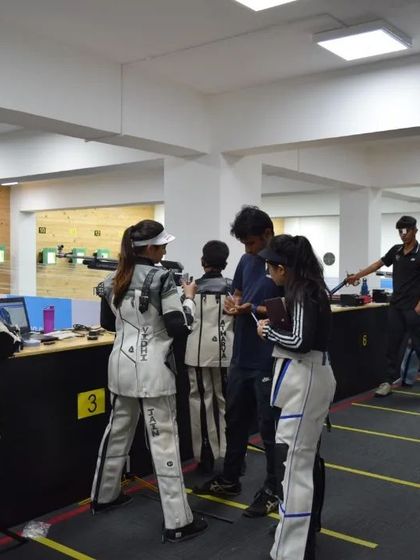 The range is buzzing with activity as shooters prepare for the Nationals. I am seen here providing last-minute guidance and feedback to an athlete.