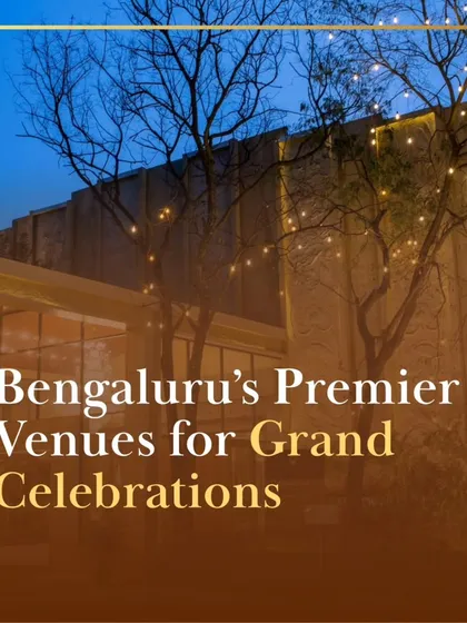 The exterior of one of our premier venues at dusk, with trees adorned with fairy lights. This image captures the enchanting and celebratory atmosphere we create for grand evening events.