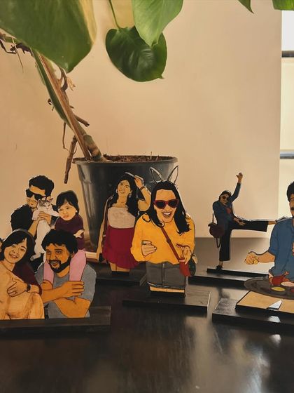 A collection of some of the custom wooden miniatures I've created. You can see the variety of poses and people, from family groups to individual portraits, each with its own stand.