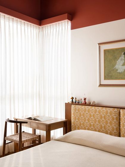 This kids' bedroom shows the custom bed with its unique headboard and an adjacent study desk. I design furniture that grows with a child, providing spaces for both rest and creativity.