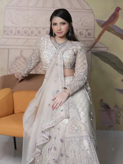 Another angle of the ivory rental lehenga, highlighting the full-sleeve blouse and the flow of the skirt.