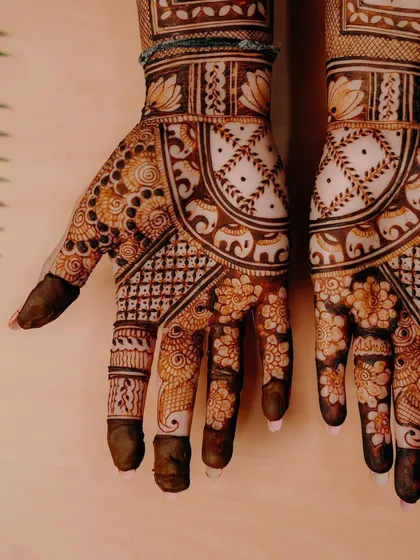 A close-up shot against a light wood background, highlighting the clean lines and beautiful floral and elephant motifs.