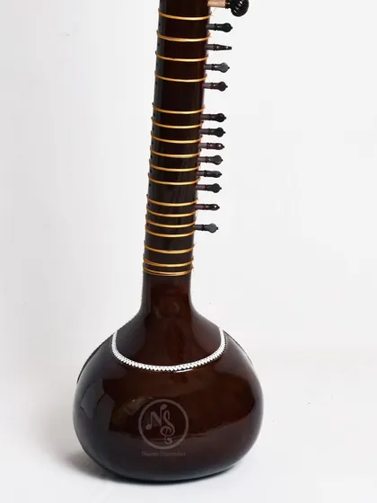 The back of an Ustad Vilayat Khan style sitar. The smooth finish and simple line decoration highlight the quality of the wood and the gourd.