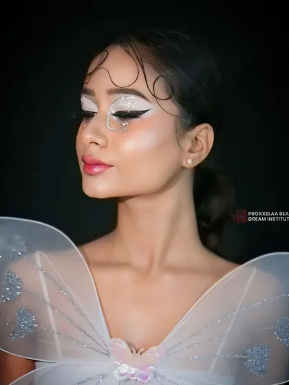 The full fairy look with shimmering wings. The makeup is designed to be ethereal and otherworldly, perfect for a fantasy-themed shoot or event.