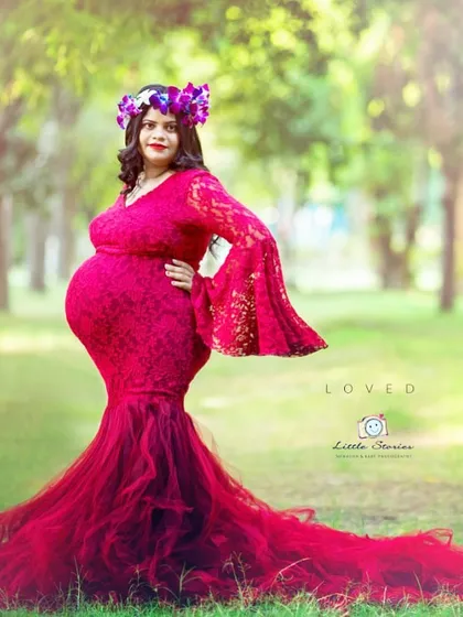 An outdoor setting provides the perfect canvas for a bold, statement-making portrait. The vibrant red of this gown stands out beautifully against the soft greens of the park.