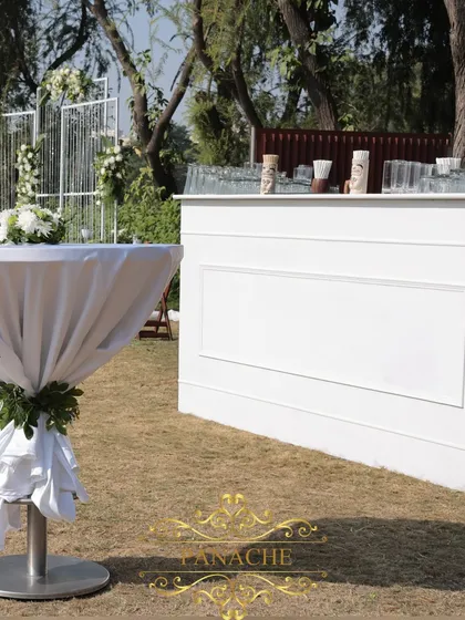 The clean, all-white bar setup for the outdoor engagement party.