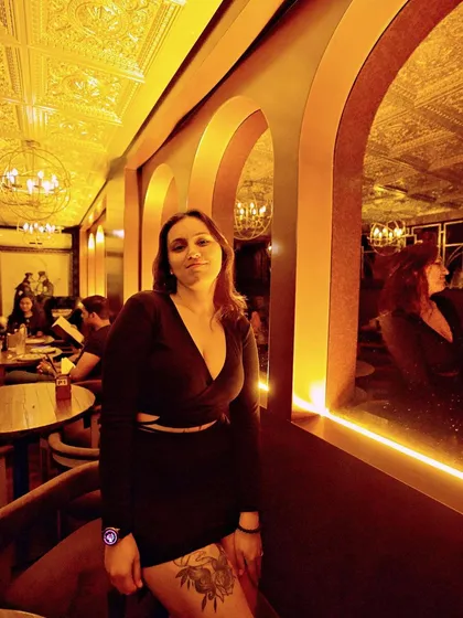A guest posing in the warm, ambient lighting of the club.
