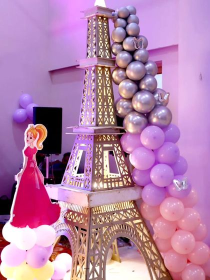 A unique Eiffel Tower prop decorated with a cascade of balloons, adding a touch of Parisian glamour to the princess theme.