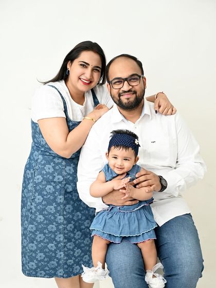 A happy family of three, twinning in denim. This simple, clean, and modern family portrait is all about their bright smiles and clear connection.