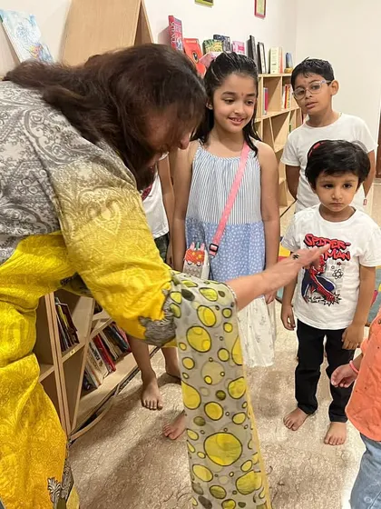 A sweet moment during our Ganesh Chaturthi celebration, where an instructor interacts with the children, making them feel special and included.