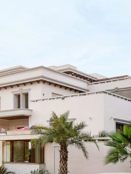 This architectural masterpiece unfolds in every corner. From the warm embrace of wooden accents to the tranquil greens of the palm trees, this house is a living canvas of sophistication.