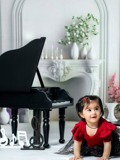 We were given hands to serve and a heart to love. A curious toddler explores the floor of our piano-themed studio.