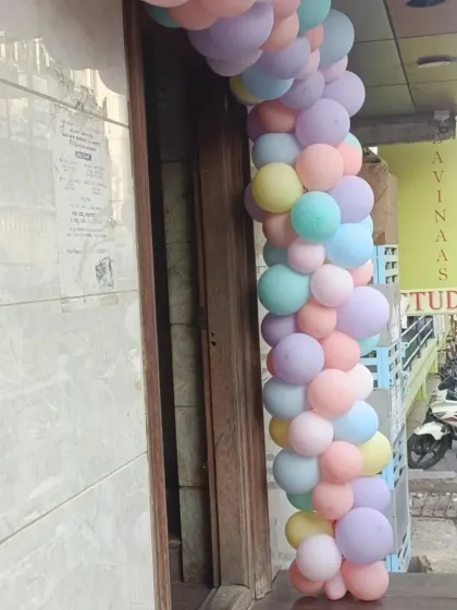 A beautiful pastel balloon garland framing the entrance to a birthday party venue. The soft colors create a dreamy and inviting atmosphere right from the start.