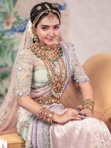 A timeless beauty in a modern-twist traditional saree. This shot captures the elegance of the outfit and the model's poise, set against a soft, artistic backdrop.