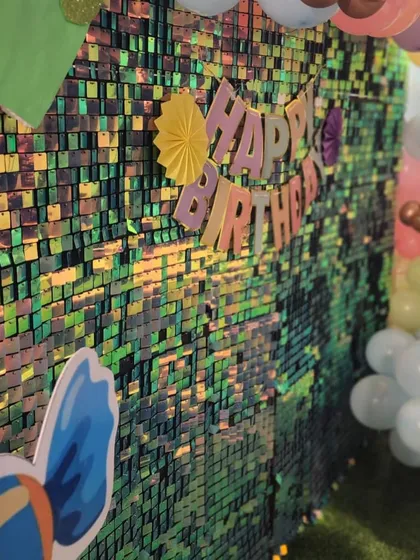 A close-up of the iridescent sequin wall used in our Candyland theme. It catches the light beautifully and creates a dazzling effect for photos.