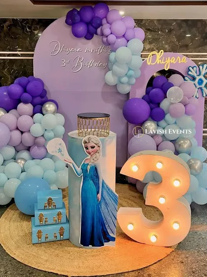 A magical Frozen-themed third birthday party with an Elsa cutout and snowflake details.