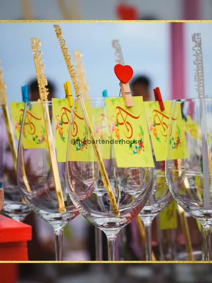 We love creating a cohesive look. These glasses are all adorned with custom couple's tags and elegant golden sugar stirrers, ready for a toast to love.