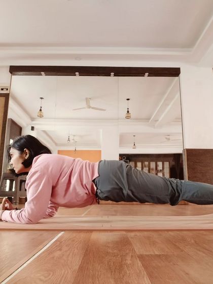 Holding Phalakasana (Plank Pose) to build core strength. Nurturing your body with consistent practice is the best way to nurture your mind.
