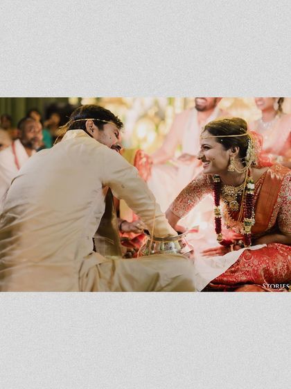 The playful interaction between Nihal and Sravanthi during their wedding rituals, a genuine smile that tells a story of their connection.