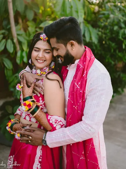 Wrapped in an embrace and surrounded by the vibrant colors of their Haldi ceremony outfits, this couple's joy is infectious. It's a perfect capture of pre-wedding excitement and love.
