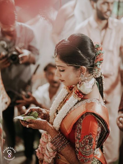A profile shot of the bride during a wedding ritual, focusing on her serene expression.