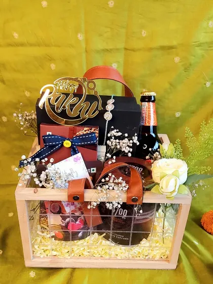 The Maverick Man Rakhi Hamper is for the brother with cool taste. It includes a non-alcoholic beer, gourmet popcorn, and other stylish goodies in a pinewood basket.