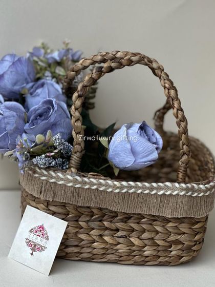 This simple yet elegant woven basket with blue flowers is a beautiful way to present a small gift or favour. The natural texture of the basket pairs wonderfully with the soft flowers.