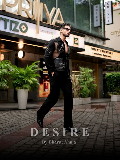 Confidence tailored to perfection. This shot shows the full silhouette of the black utility shirt, a piece that combines fearless individuality with functional design.