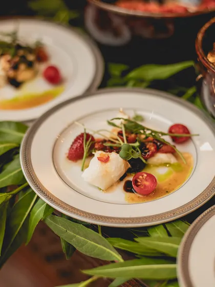 Our Burrata di Puglia, artfully arranged with chilli jam, basil pesto, and cherry tomatoes. The dish is a study in contrasts: creamy and spicy, traditional and modern.