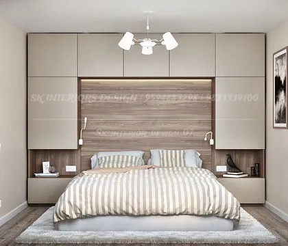A practical and stylish bedroom design with storage cabinets built above and around the bed. The combination of beige laminate and a wood-finish headboard creates a warm and cozy atmosphere.