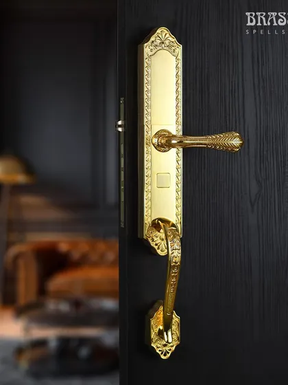 The same Ultra Series smart lock is shown against a dark, moody interior, highlighting its versatility. The intricate brass detailing and gold finish create a luxurious focal point, ensuring your home's first line of defense is also its most stylish statement.