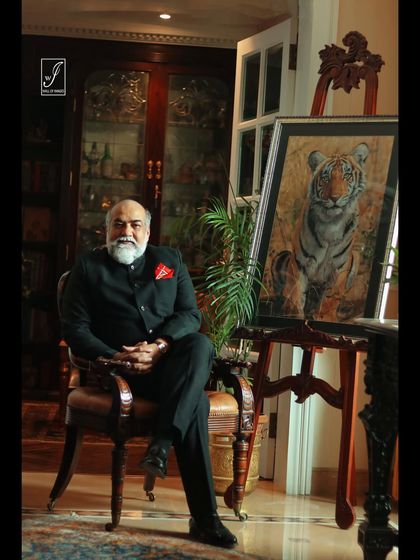 A wider shot that captures more of the luxurious office environment, reinforcing the subject's professional stature.