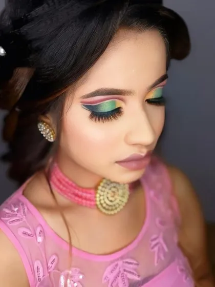 A vibrant and creative makeup look for a party or special event. This style shows how we can play with color, featuring sharp, winged eyeliner and a multi tonal eyeshadow design.