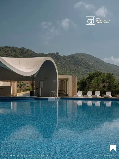 A feature in The Architect's Diary showing the expansive pool and lounge area of our Aqua project, set against the backdrop of the Karnataka hills.