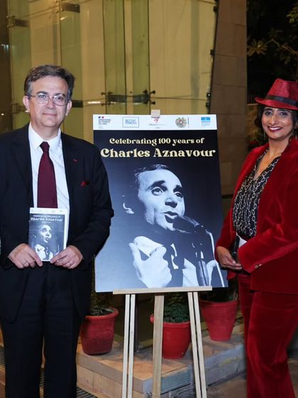 Dignitaries, including the Ambassador of France to India, pose for a photo at the Charles Aznavour musical evening. Our events attract esteemed guests from the diplomatic and cultural spheres.
