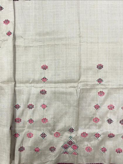 A light-colored cotton fabric with delicate pink and black Kasuti butis. This is perfect for creating elegant, lightweight apparel.