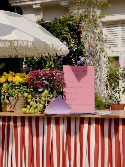 A detail from the Spanish-themed Haldi. We set up a mocktail bar with a vibrant red and white striped base, topped with fresh fruits and flowers, adding to the Mediterranean market feel.