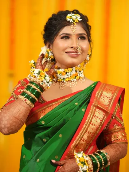 The bride looks radiant against the bright yellow backdrop of her Haldi ceremony.