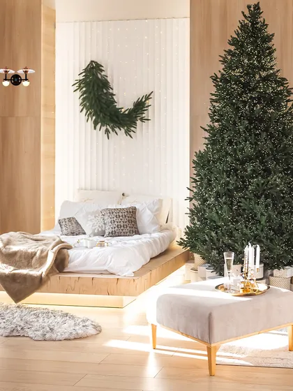 This bedroom features a single woven pendant, adding a touch of natural texture to the festive decor. The lighting helps create a serene and celebratory atmosphere for the holidays.